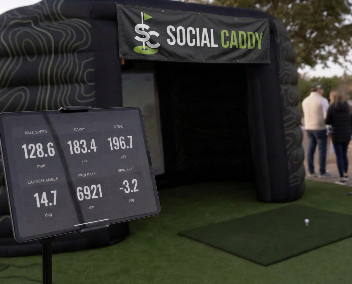 Golfer finishing a swing beside a launch monitor in a golf simulator bay